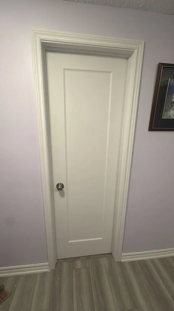 White door with a doorknob, light blue wall in the background.