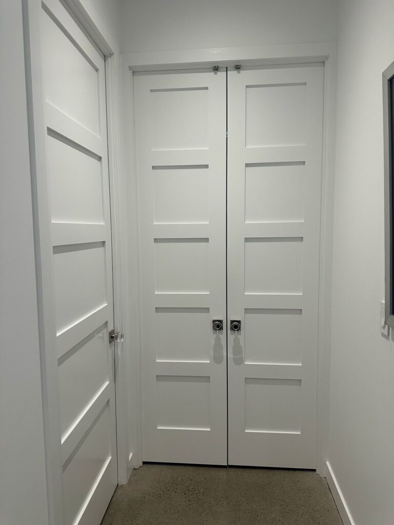 White interior double doors in a hallway
