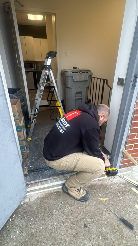 Technician repairing a door frame base